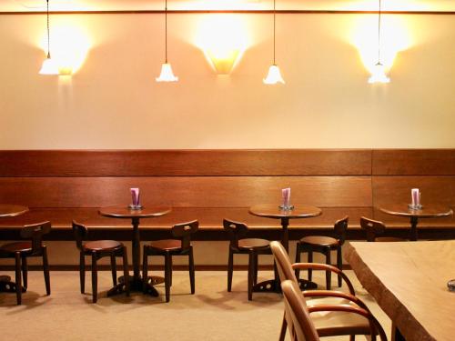 a dining room with tables and chairs and lights at Appi Arts Color in Hachimantai