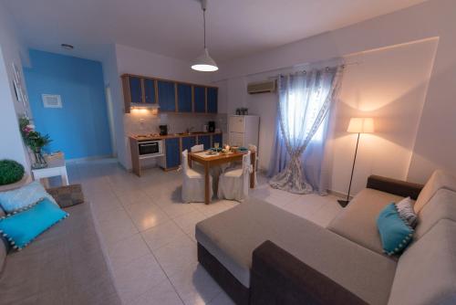 a large living room with a couch and a kitchen at Saraya Resort in Alinda
