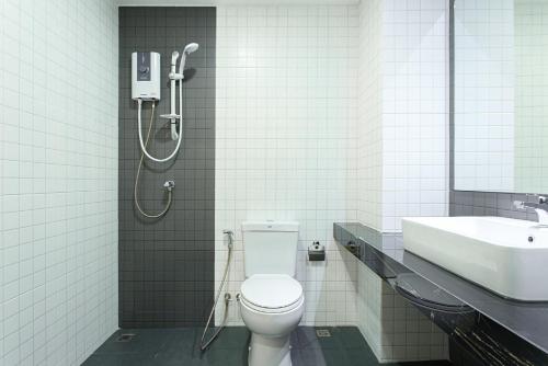 a bathroom with a shower and a toilet and a sink at CHANAPAT APARTMENT in Chiang Mai