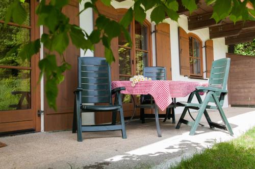 a table and chairs on the porch of a house at Am Sonnenhang inkl. Chiemgaukarte in Ruhpolding
