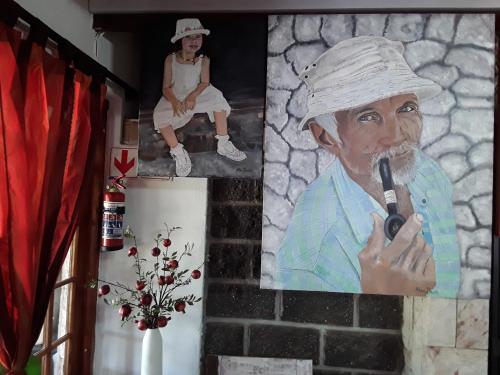 a painting of a man smoking a pipe next to a woman at Art Guest House in Lutzville