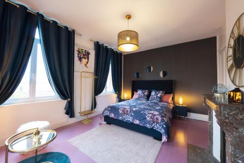 a bedroom with a bed with a blue bedspread at Domaine Les Tilleuls in Wailly-Beaucamp