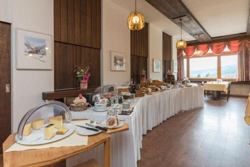 einen langen Tisch mit weißen Tischdecken in einem Zimmer in der Unterkunft Hotel Sporting in Marbach