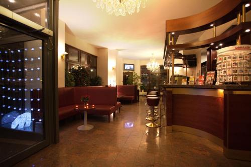a restaurant with a bar and a wine cellar at Hotel Orion Berlin in Berlin