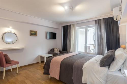 a hotel room with a bed and a window at UrbanStay in Athens