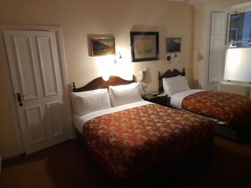 a hotel room with a bed and a desk at Red Setter Townhouse Bed & Breakfast in Carlow