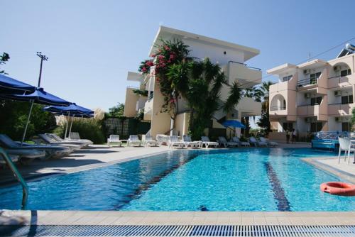 a swimming pool in front of a building at Artemis Comfort&Pleasure in Faliraki