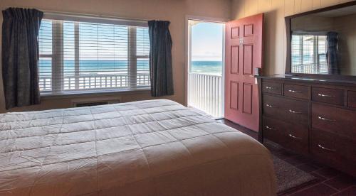 a bedroom with a large bed and a large window at Copley LaReine Motel in Old Orchard Beach