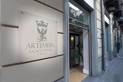 a sign on the side of a building at Artemisia Palace Hotel in Palermo
