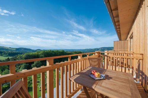 a wooden deck with a wooden table with fruit on it at RETTER Bio-Natur-Resort in Pöllauberg
