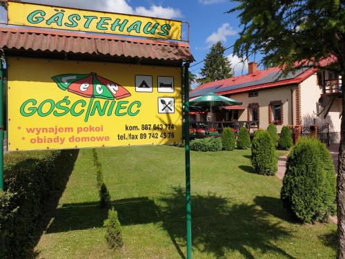 a sign for a restaurant in front of a building at Gościniec LECH in Kosewo