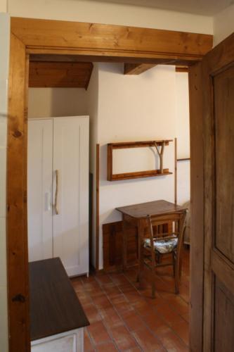a kitchen with a table and a table and a refrigerator at Country House Ca' Vernaccia in Urbino