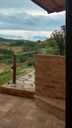 a balcony with a fence and a stone walkway at Country House Ca' Vernaccia in Urbino