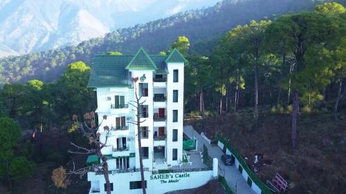 an aerial view of a resort building on a hill at Hotel Saheb's Castle McLeodganj in McLeod Ganj