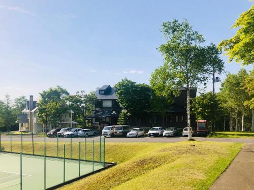 a street with cars parked in front of a building at Appi Life is Beautiful in Hachimantai