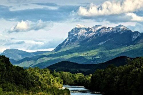 a view of a mountain range with a river and trees at Les Terrasses de Saillans in Saillans