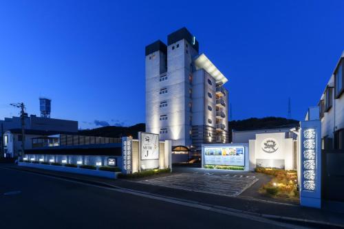 a tall building with lights on the side of a street at HOTEL MYTH-J -ホテル マイス ジェイ- adult only in Sakaide