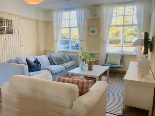 a living room with two couches and a table at Vakantiehuis Dorpsplein in Koudekerke