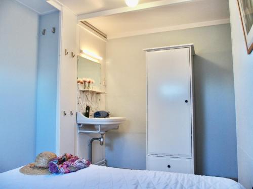 a bathroom with a bed and a sink and a mirror at Vakantiehuis Dorpsplein in Koudekerke