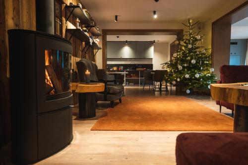 a living room with a fireplace and a christmas tree at Willa 74 Wisła in Wisła