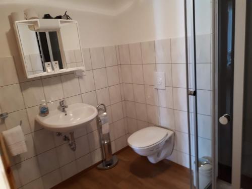 a bathroom with a toilet and a sink at Monteurhotel B27 in Rottweil