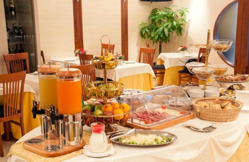 a table with a buffet of food and drinks at Hotel Tiempo in Naples