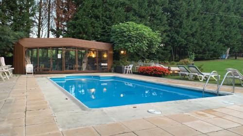 a swimming pool in a backyard with a gazebo at Agroturismo Anziola in Oiartzun