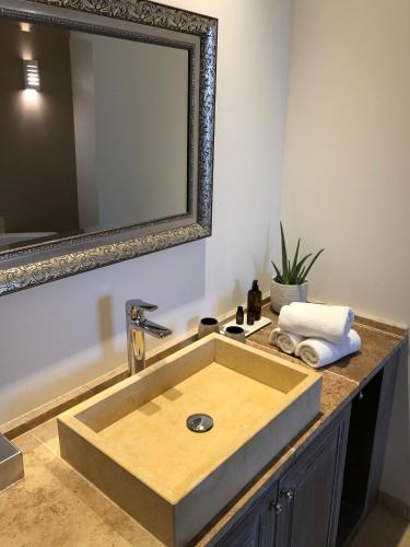 a bathroom with a wooden sink and a mirror at The Starnbergsee Hideaway in Seeshaupt
