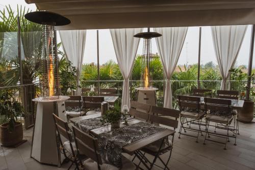 a restaurant with tables and chairs and windows at La Corte sul Naviglio in Boffalora sopra Ticino