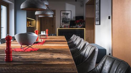 a room with a long table with chairs and a fireplace at Willa 74 Wisła in Wisła