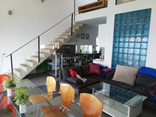 a living room with a couch and a staircase at LOFT-Beach-apartments RATKO in Novi Vinodolski