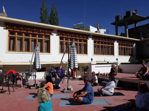 a group of people sitting in front of a building at Smanla guest house in Leh