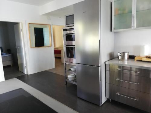a kitchen with a large stainless steel refrigerator at LOFT-Beach-apartments RATKO in Novi Vinodolski