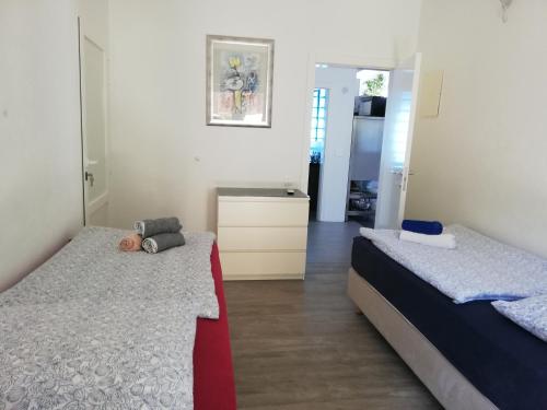 a bedroom with two beds and a dresser in it at LOFT-Beach-apartments RATKO in Novi Vinodolski