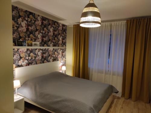 a bedroom with a bed and a large window at Apartment Paula in Saldus
