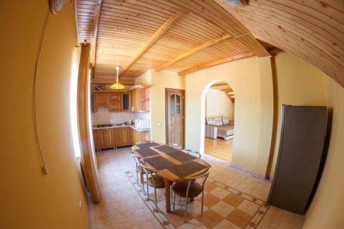 a dining room with a table and a kitchen at Passage Apartments in Skhidnitsa