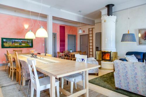 a dining room with a table and chairs and a fireplace at Kullagården in Vreta Kloster
