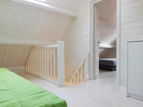 a bedroom with a bunk bed and a staircase at Nadmórz Sztutowo in Sztutowo