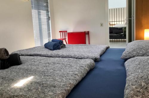 a bedroom with two beds with a blue blanket at LOFT-Beach-apartments RATKO in Novi Vinodolski