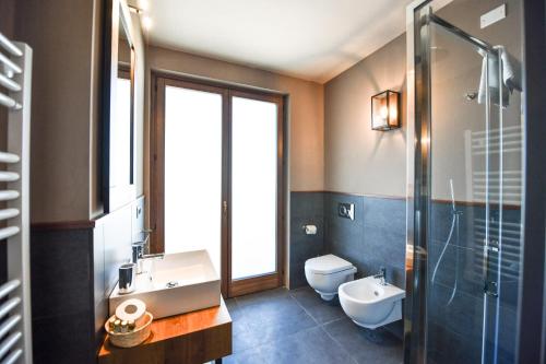 a bathroom with a sink and a toilet and a shower at Chalet Everest - Luxury Apartments in Prato Nevoso