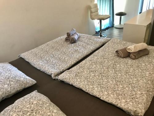 a bed with two pillows on it in a room at LOFT-Beach-apartments RATKO in Novi Vinodolski