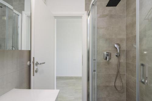 a bathroom with a shower with a glass door at Villa Anđelo in Trogir