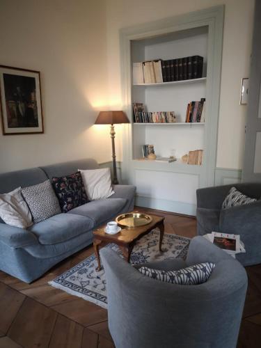 a living room with two couches and a coffee table at Les chambres chez Grand-mère à Chambéry in Chambéry