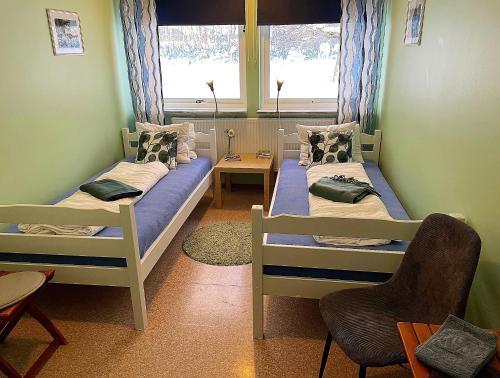 a room with two beds and a window at Hällefors Vandrarhem-Hostel & Kanotcenter in Hällefors