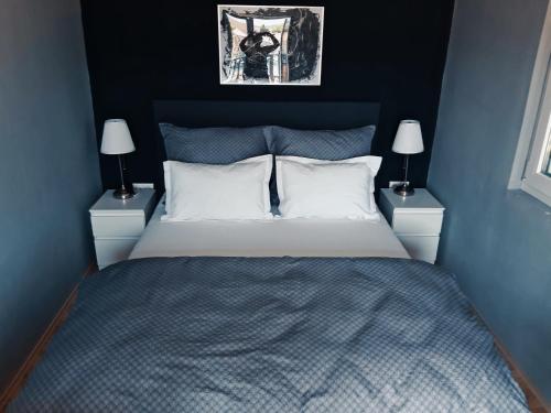 a bedroom with a large bed with two night stands at Mediteran Hvar - Modern Rooms and Restaurant, B&B in Vrboska