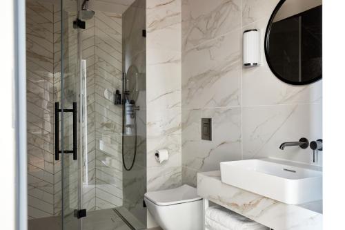 a bathroom with a toilet and a sink and a shower at Crowne Plaza - Warsaw - The HUB by IHG in Warsaw