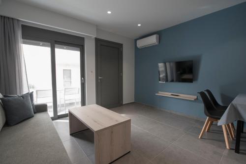 a living room with a couch and a table at NM Apartments in Mastichari