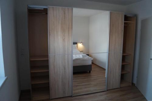 a bedroom with a closet with a bed in it at FEWO Außerlechner in Innsbruck