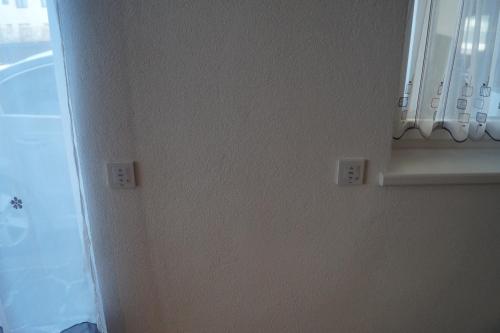 a corner of a room with two switches on a wall at FEWO Außerlechner in Innsbruck