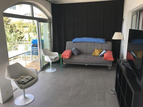 a living room with a couch and two chairs at LOFT-Beach-apartments RATKO in Novi Vinodolski